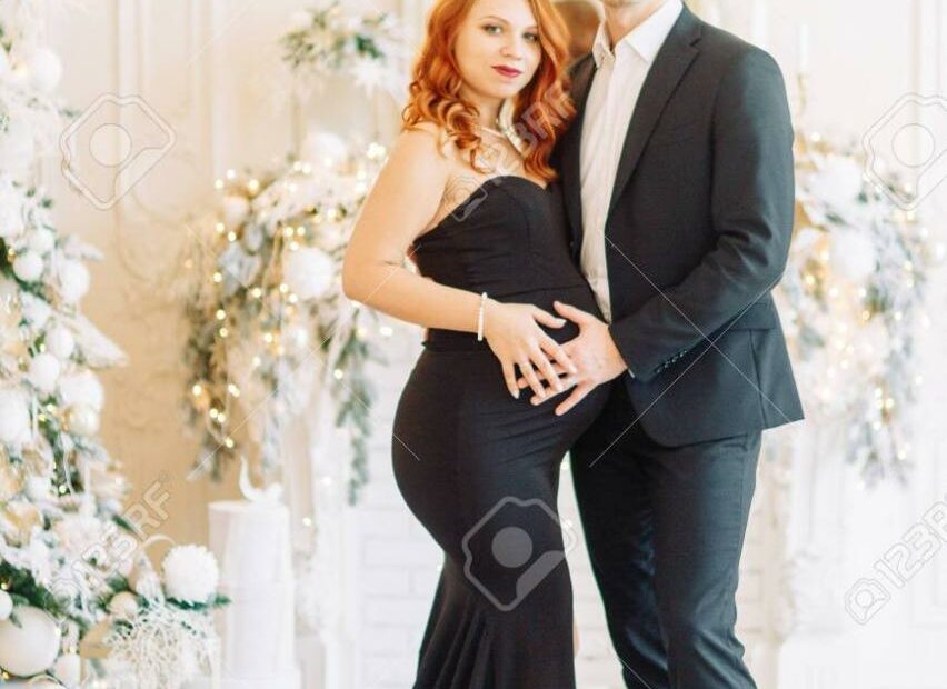 Family Expecting A Baby. Beautiful Stylish Couple In The Christmas Studio  In The Evening Images. Stock Photo, Picture And Royalty Free Image. Image  147974709.