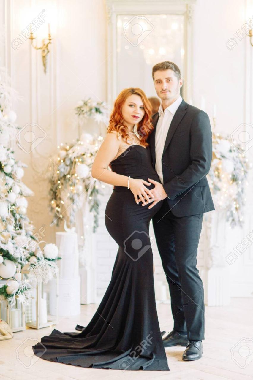 Family Expecting A Baby. Beautiful Stylish Couple In The Christmas Studio  In The Evening Images. Stock Photo, Picture And Royalty Free Image. Image  147974709.