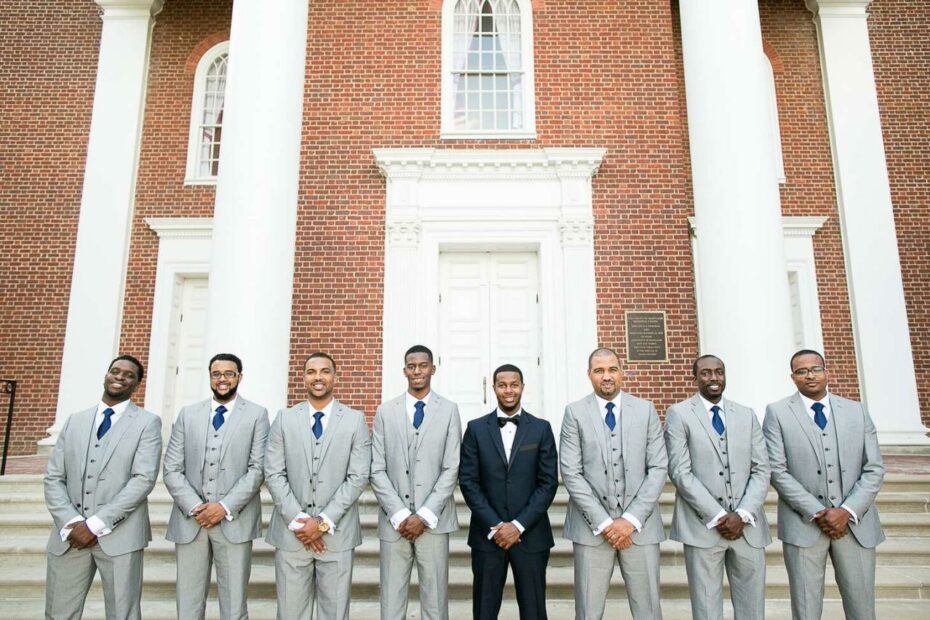 Groomsmen In Gray Suits And Navy Ties, Groom In A Black Tuxedo