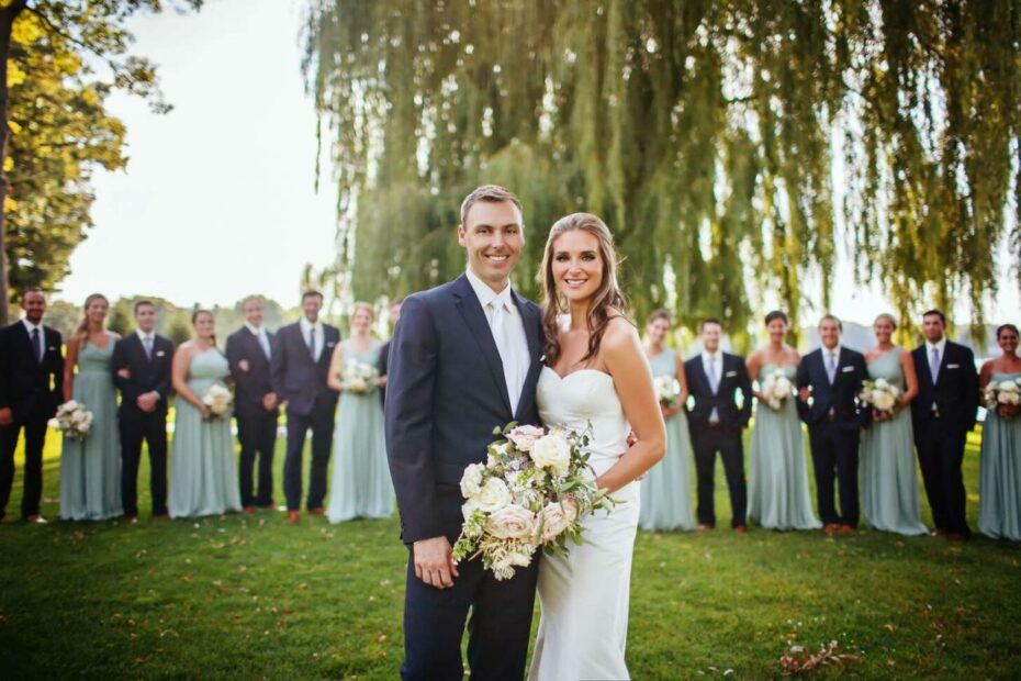 Bridal Party In Sage Dresses And Navy Suits