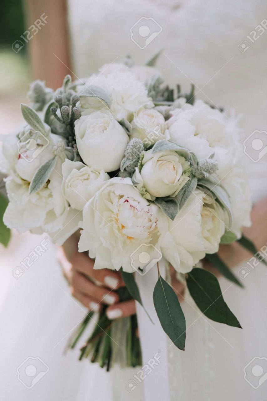 Beautiful Elegant Wedding Bouquet Of White Peonies In The Hands Of The Bride.  Vertical Stock Photo, Picture And Royalty Free Image. Image 97061924.